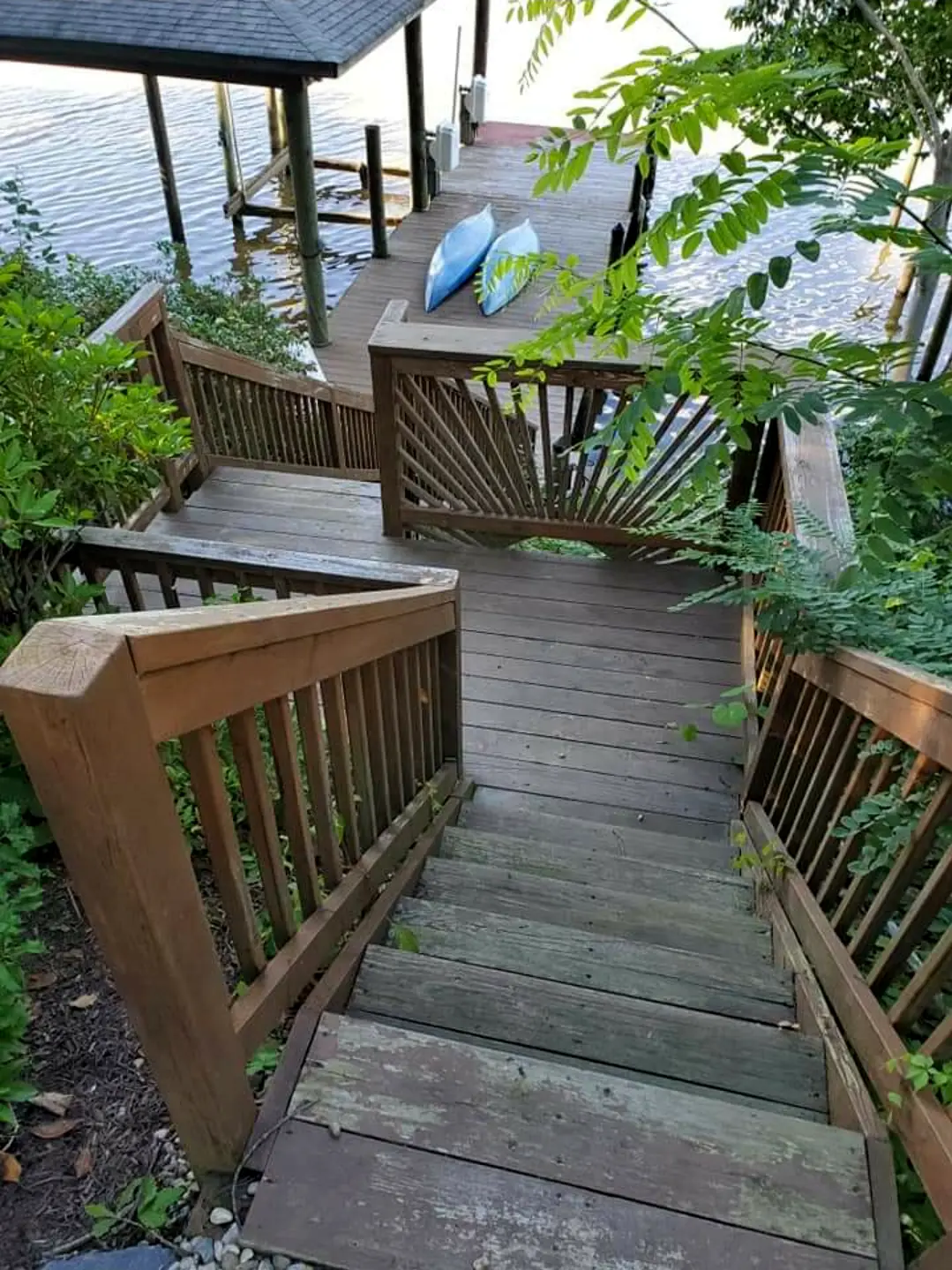 Before: Weathered gray wood stairs and pier leading down to a covered boat dock